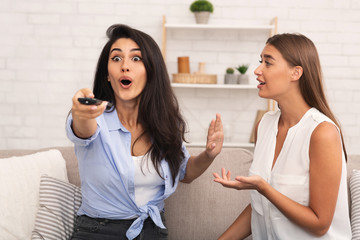 Girl Not Listening To Friend Sitting On Couch Indoor
