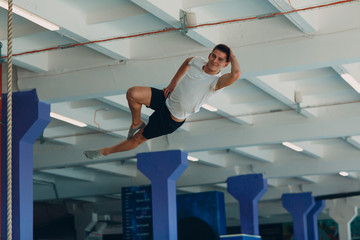 Young male acrobat jumping on a trampoline