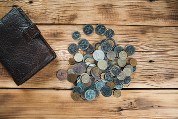 Obraz na płótnie Canvas calculator with coins on the wooden desk