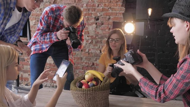 hobby photography, a professional photographer conducts a master class on photo shooting food for young creative people in a fashion studio