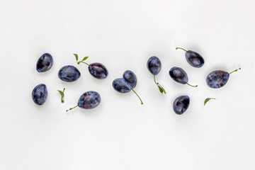 Plum pattern on white. Fruit group top view, flat lay.