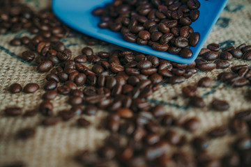 Coffee spoon, modern coffee scale and coffee grinder on old table