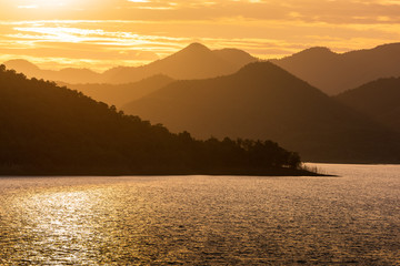 sunset travel landscape, jetty with mountains in the background