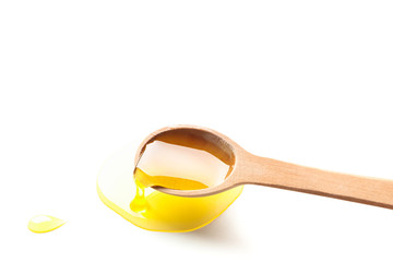 Wooden spoon with honey isolated on white background, closeup