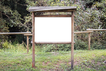 Empty wooden billboard in the nature. Signboard made of wood with white space for text and graphics...