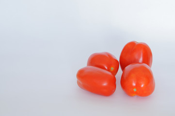 red tomatoes on a white background
