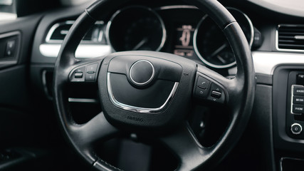 Fototapeta na wymiar Interior car. Black steering wheel of the car.