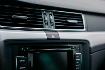 Emergency gang button and the air conditioner grille close up.