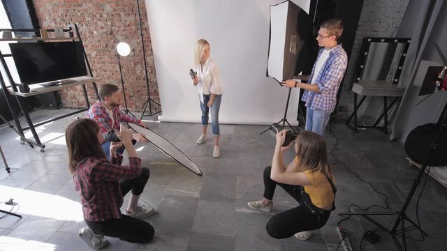 professional beautiful model poses for camera during fashionable workshop on photography for modern photo studio in studio