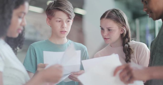 High school students opening their exam results