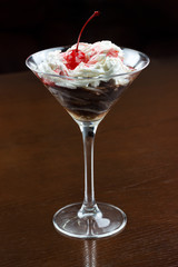 dessert with chocolate icing, jam and cherry