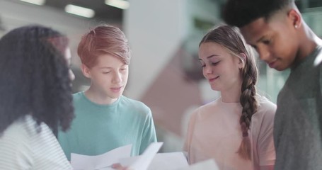 High school students opening their exam results - Powered by Adobe