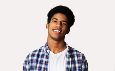 Portrait of happy young african guy on white background