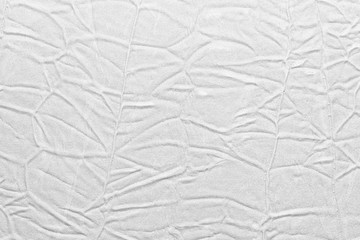 White crumpled leather texture. fabric with folds imitation under genuine leather. background. wallpaper
