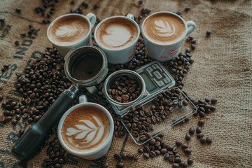 Coffee spoon, modern coffee scale,cup of coffee and coffee grinder on old table