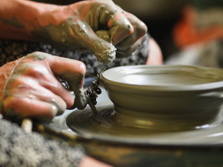 Making Ceramic Molds: Hands molding pottery. Mugs made of clay