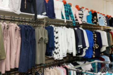 Сlothing boutique store interior blurred background.  Defocused fashion clothing store