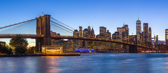 New York City skyline buildings Brooklyn Bridge evening sunset