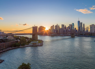 New York City skyline buildings Brooklyn Bridge evening sunset