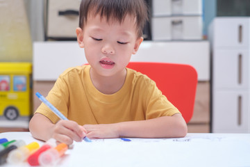 Cute Asian 3 - 4 years old toddler boy child writing / drawing with pencil, Student doing homework, Little kid prepare for kindergarten test, Creative play for toddler, improve focus in child concept