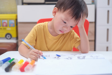 Cute Asian 3 - 4 years old toddler boy child writing / drawing with pencil, Student doing homework, Little kid prepare for kindergarten test, Creative play for toddler, improve focus in child concept