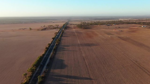 Nice view from above the long empty countryside road and the wide crop field