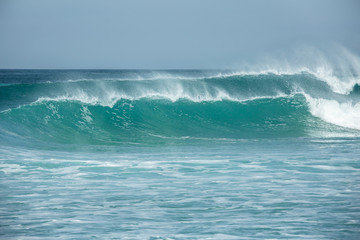 Rolling turquoise surf breaks at Fistral beach in Cornwall