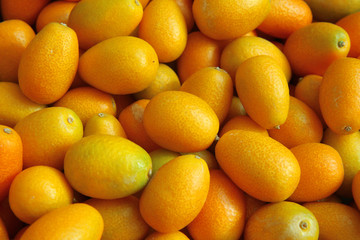 Bunch of fresh kumquats fruits in the organic food market