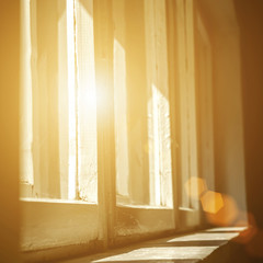 bright daylight is shining through old window with wooden frame into retro vintage room, interior...