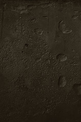 Urban concrete wall background with grooves and bubbles. Cement gray wall. Urban and industrialization art concept. Texture like concrete, stone, cement, plaster.. Poster mockup. Сloseup studio shot.