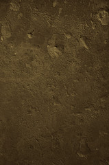 Urban concrete wall background with grooves and bubbles. Cement gray wall. Urban and industrialization art concept. Texture like concrete, stone, cement, plaster.. Poster mockup. Сloseup studio shot.