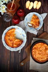 Homemade apple pie bathed with peach jam and honey. White flowers, jar of peach jam and honey....