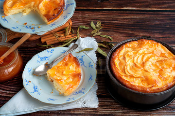 Homemade apple pie bathed with peach jam and honey. White flowers, jar of peach jam and honey. Fresh red apples and stevia leaves,