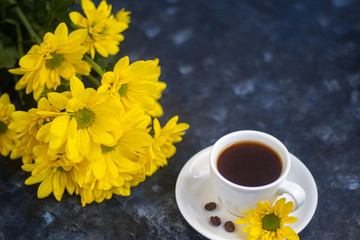 cup of tea and flowers on wooden background