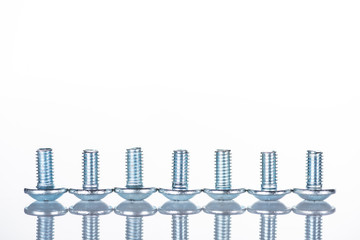 close up view of shiny short bolts isolated on white with copy space