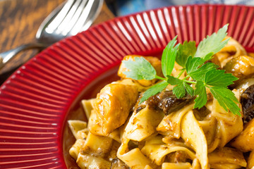 Tagliatelle pasta with chicken and boletus mushrooms.
