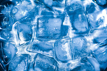 Ice cubes in the light of a blue lamp
