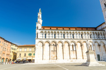 Fototapeta na wymiar Chiesa di San Michele in Foro St Michael Roman Catholic church basilica on Piazza San Michele square in historical centre of old medieval town Lucca in summer day with clear blue sky, Tuscany, Italy