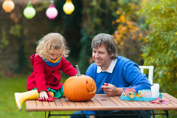 Fototapeta premium Family carving Halloween pumpkin.