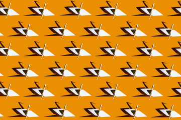 paper origami cranes collage on a bright yellow background with hard shadow
