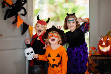 Kids trick or treat. Halloween. Child at door.