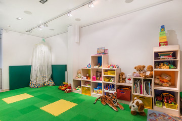 Playroom in the kindergarten with a lot of toys. Interior of bright colorful playing room for kids.