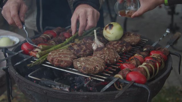 Outdoor grill with beef and vegatables in slow motion. 