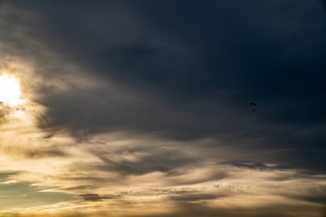Paraglider against the sunset sky