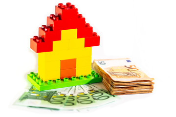 House model with stack of a euro banknote, money