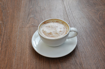 cup of coffee on wooden table