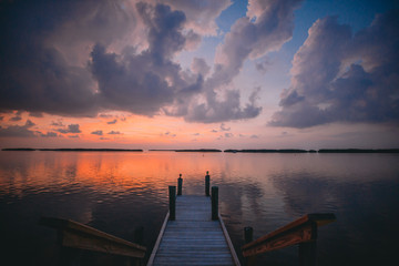 A dock overlooks the glow of the sunset in the Florida Keys
