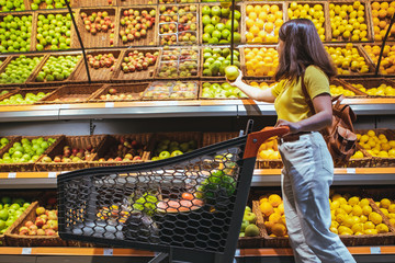 woman at grocery store market with shopping cart