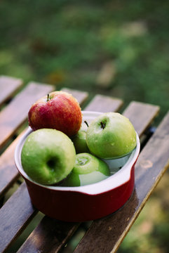 Apples in a bowl with water.