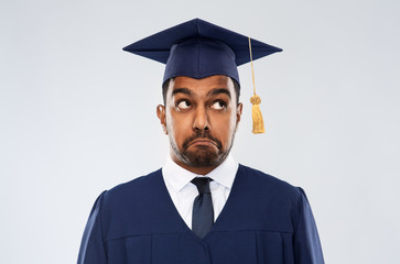 education, graduation and expression concept - confused indian male graduate student in mortar...